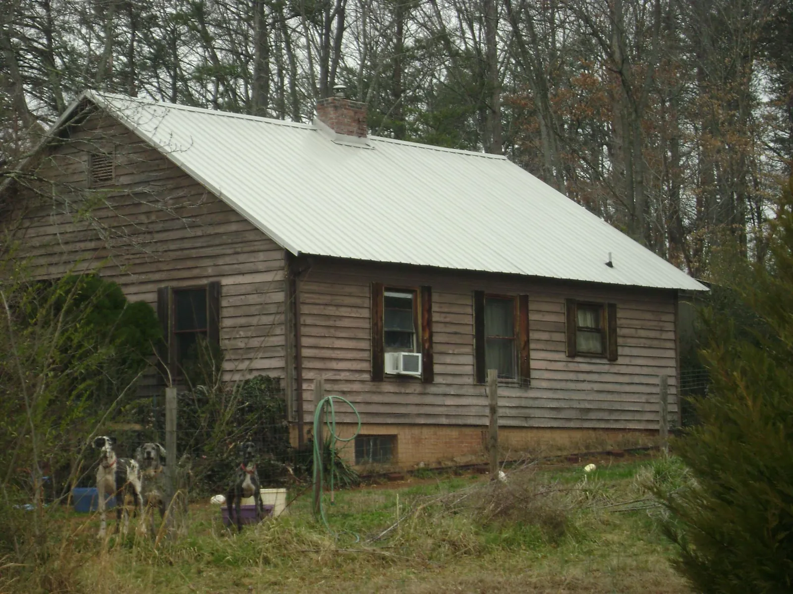 White metal roof on an old wood sided farmhouse, from a Metal Roof Installation job in Mingo